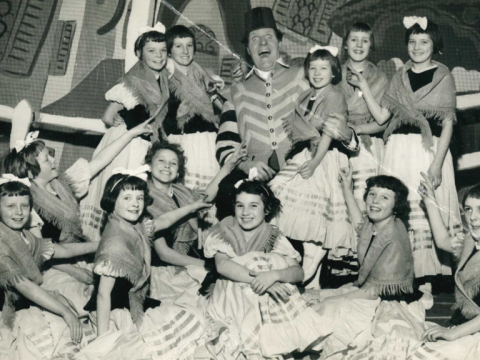 Black and white photograph of entertainer Tommy Cooper with the Sunbeams.